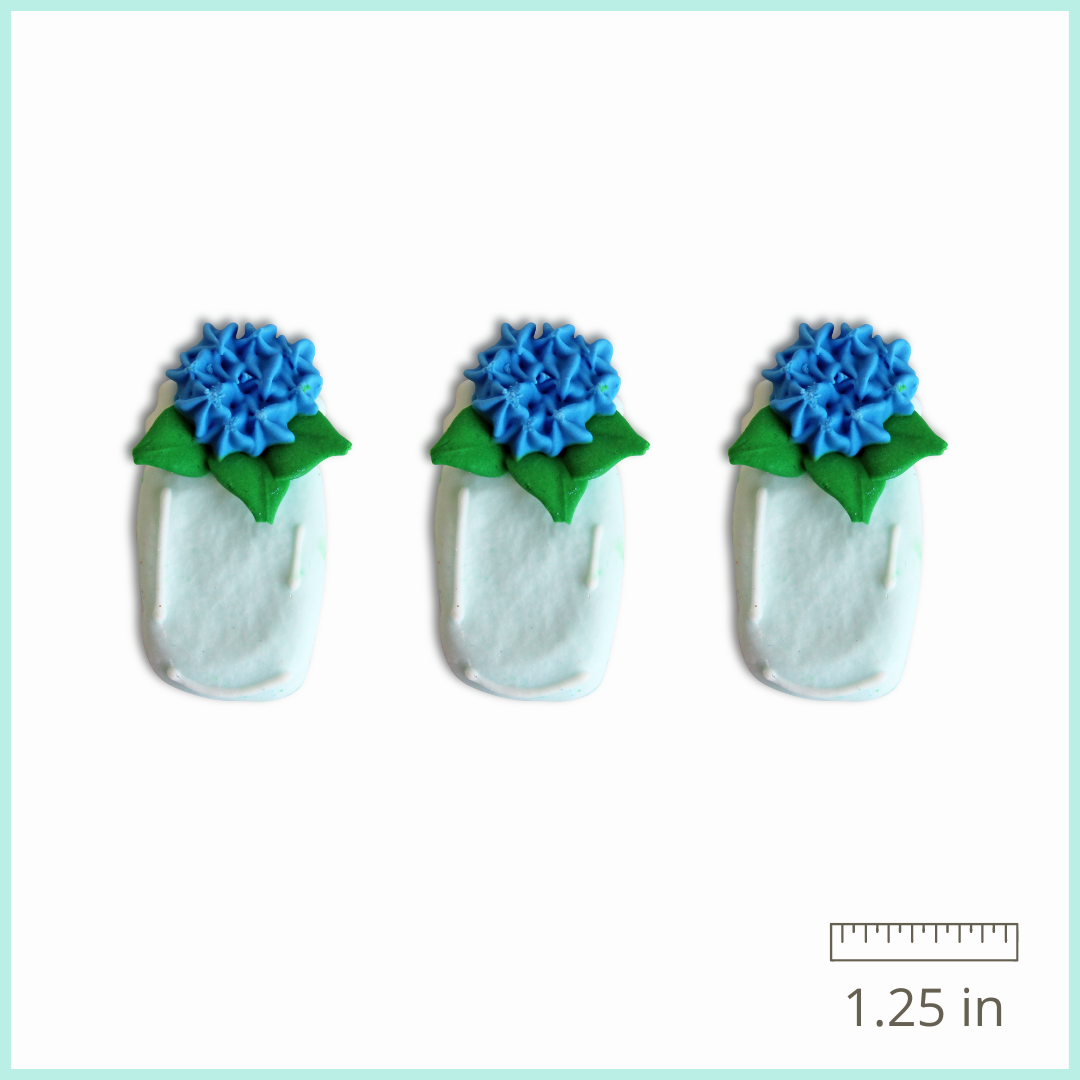 A photo of the Mason Jars with Flowers Royal Icing Decorations, featuring beautifully crafted mason jars with blue hydrangea flowers, piped with royal icing.