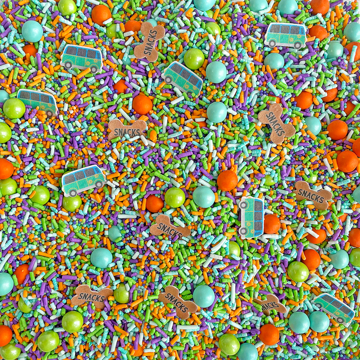 A close-up of Detective Dog Sprinkle Mix, featuring lime, purple, orange, and aqua sprinkles with wafer paper vans and dog treat shapes.
