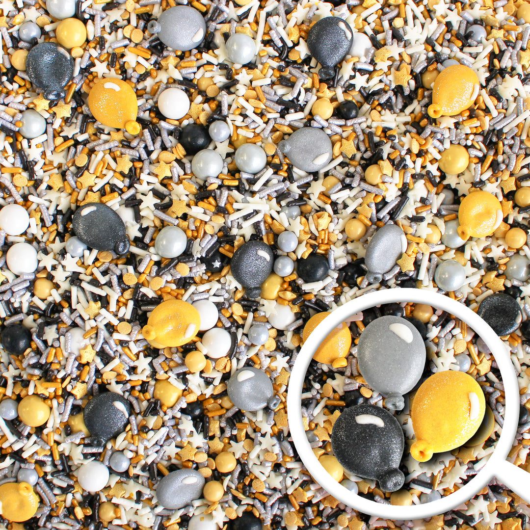 Image of Graduation Sprinkle Mix with black, gold, and silver sprinkles, and royal icing glittery balloons.