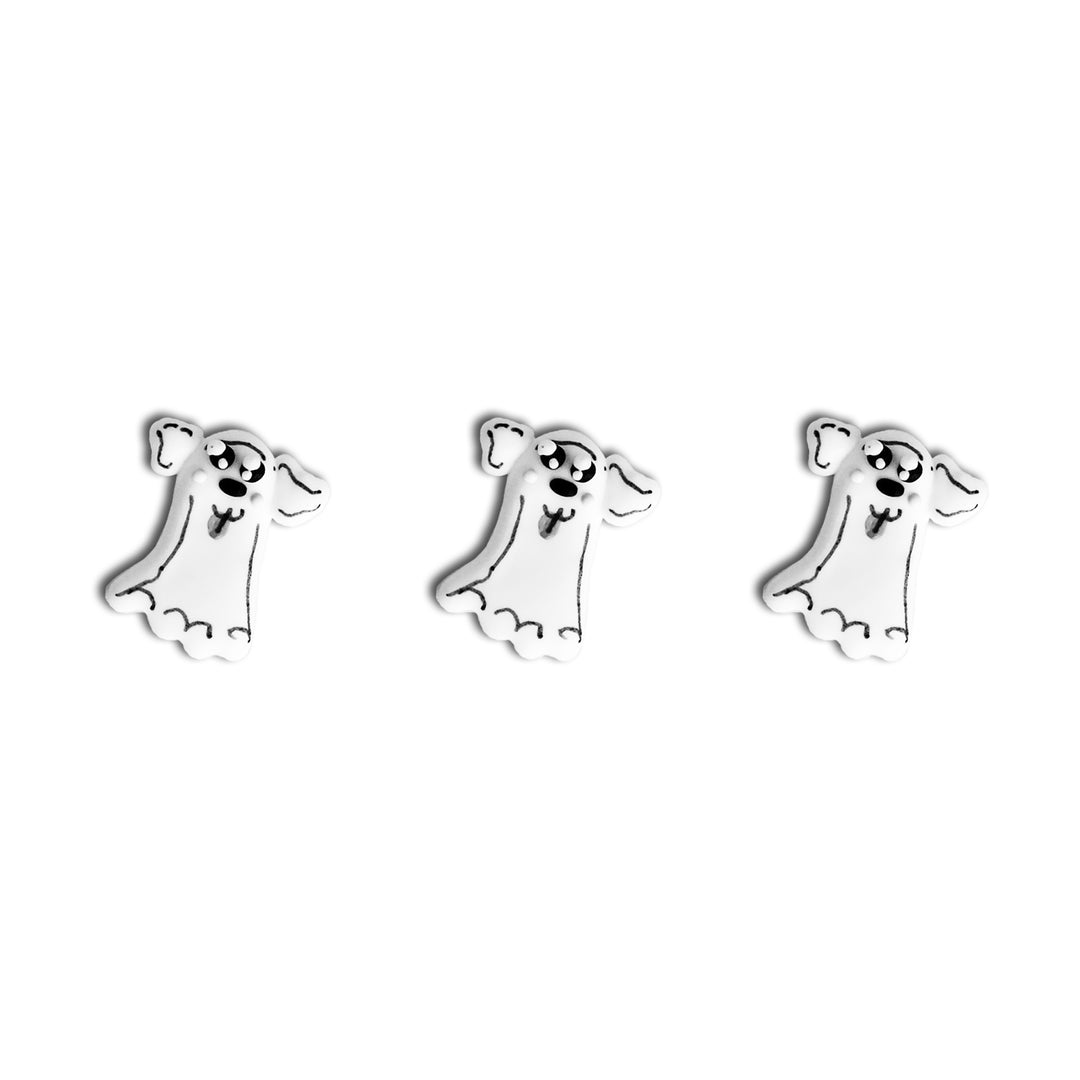 Close-up of cute dog-shaped royal icing decorations dressed up as ghosts.