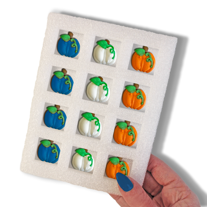 Close-up of Royal Icing Glam Pumpkins – 12 exquisite hand-piped blue, white, and orange pumpkins for upscale fall-themed treats.