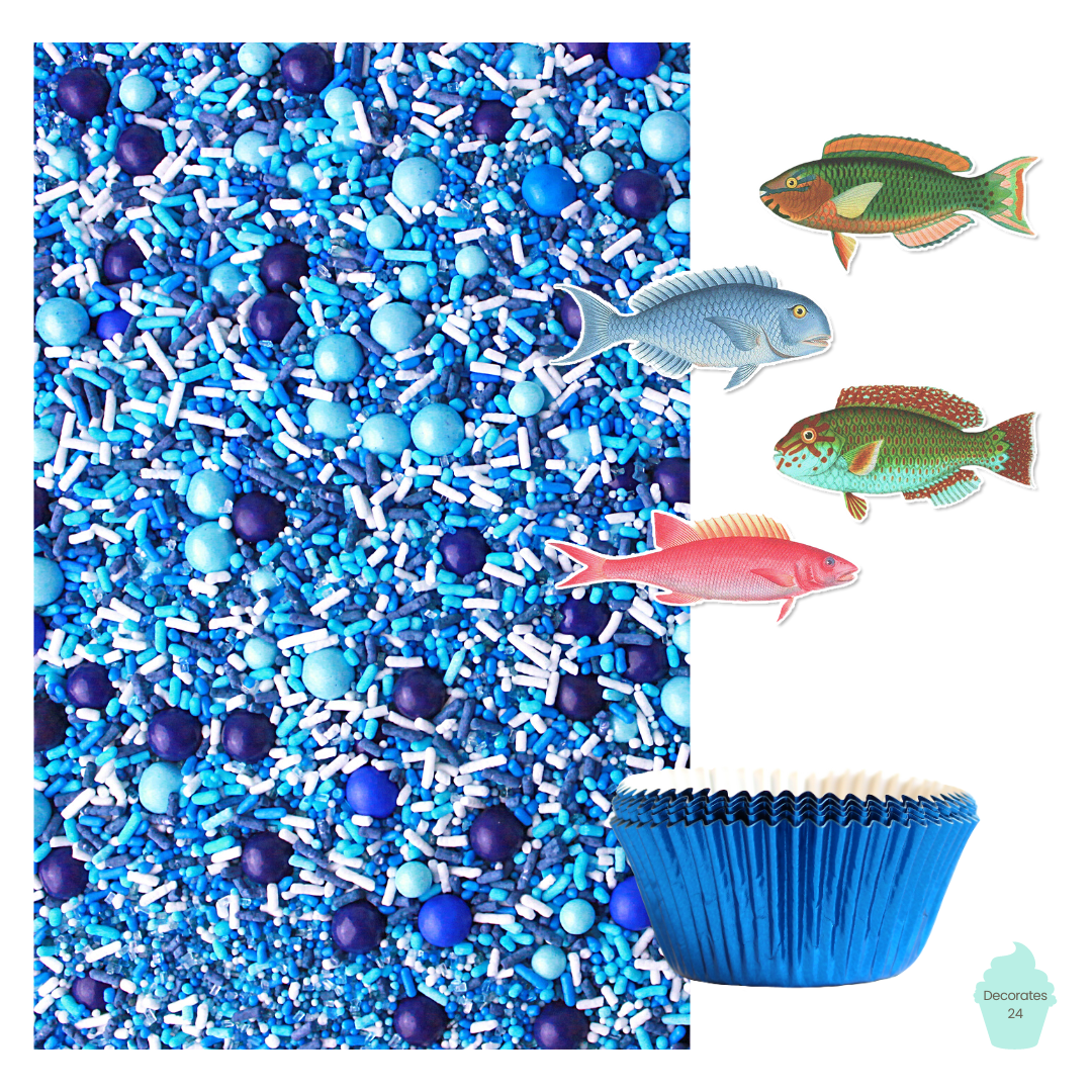 Image of cupcakes decorated with realistic fish edible wafer toppers and blue ombre sprinkle mix, sitting in blue cupcake liners.