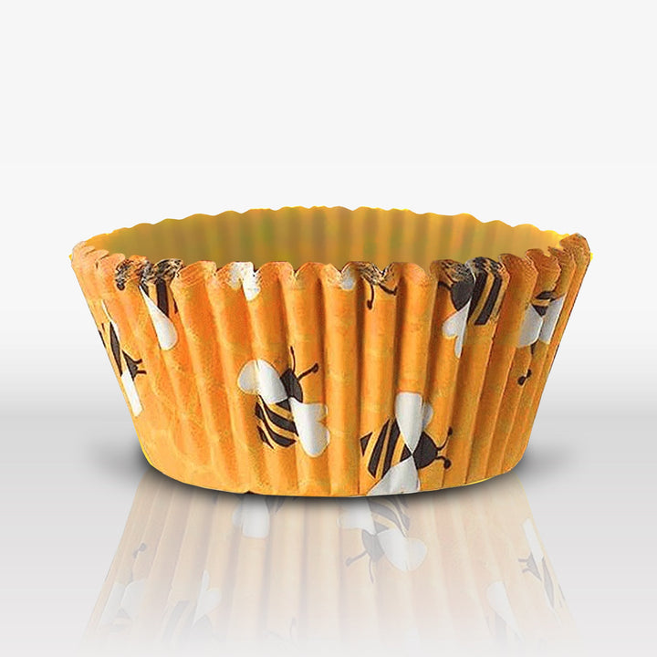 Set of Honey Bee Cupcake Liners featuring yellow and white bee and beehive patterns on a white background.