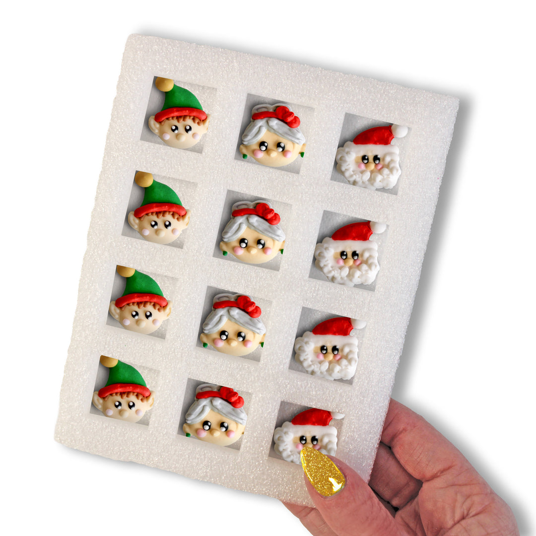 A dozen royal icing decorations by The Clause’s, depicting Santa, Mrs. Claus, and Elf for delightful and whimsical holiday treats.