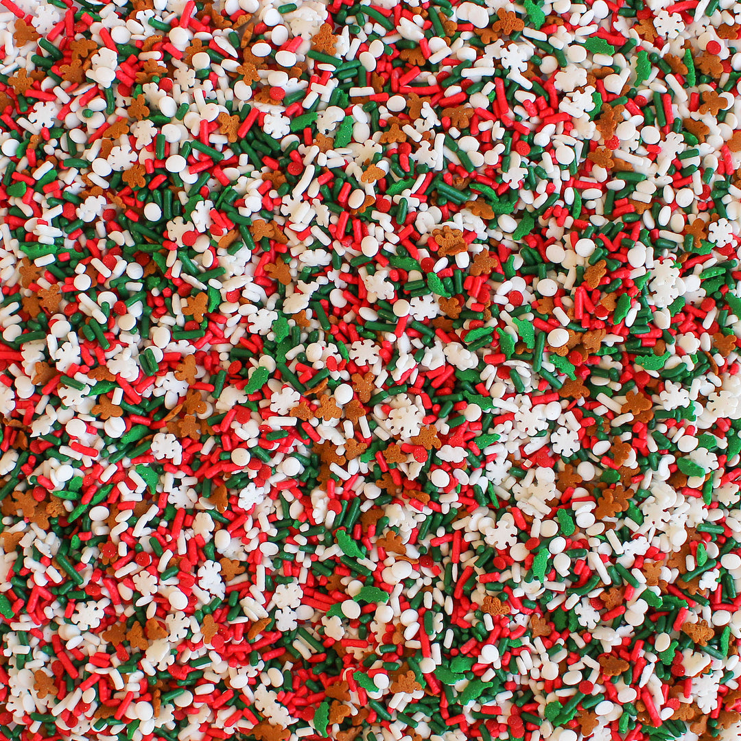 Close-up image of Happy Christmas Sprinkle Mix, showcasing its vibrant red, green, and white colors, along with adorable gingerbread men and delicate snowflakes. Perfect for Christmas desserts.