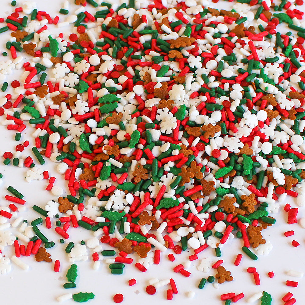 Close-up image of Happy Christmas Sprinkle Mix, showcasing its vibrant red, green, and white colors, along with adorable gingerbread men and delicate snowflakes. Perfect for Christmas desserts.