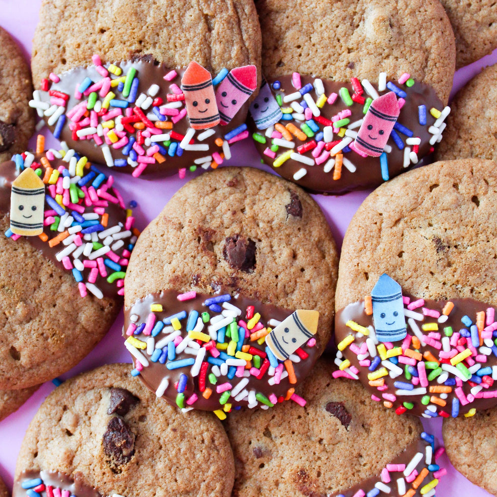 Chocolate chip cookies dipped in chocolate and sprinkled with our Crayon Sprinkle Mix