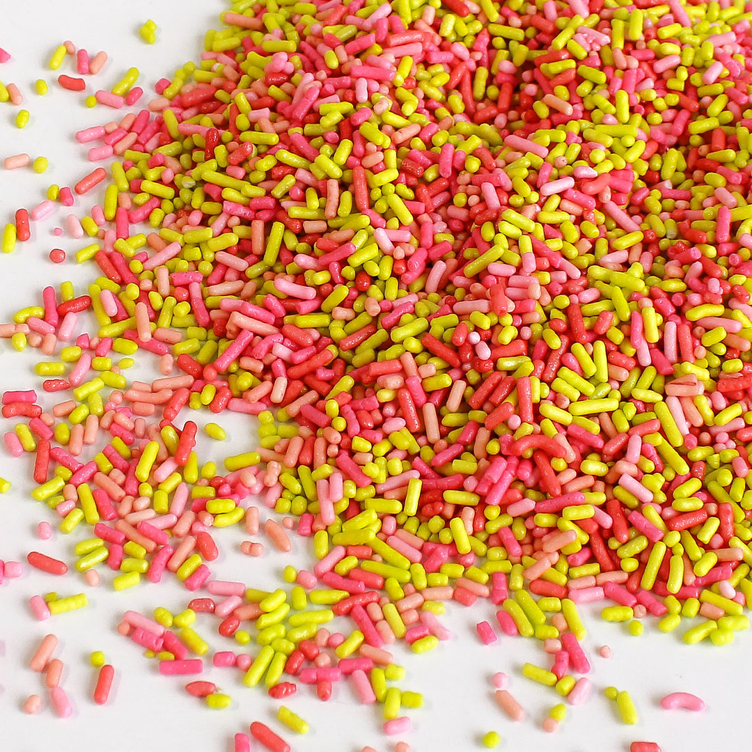 Image of Miami Beach Sprinkle Mix with bright pink, yellow, and red sprinkles in a beach-themed setting.