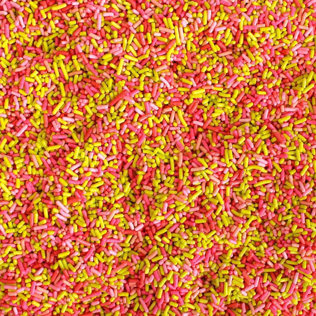 Image of Miami Beach Sprinkle Mix with bright pink, yellow, and red sprinkles in a beach-themed setting.