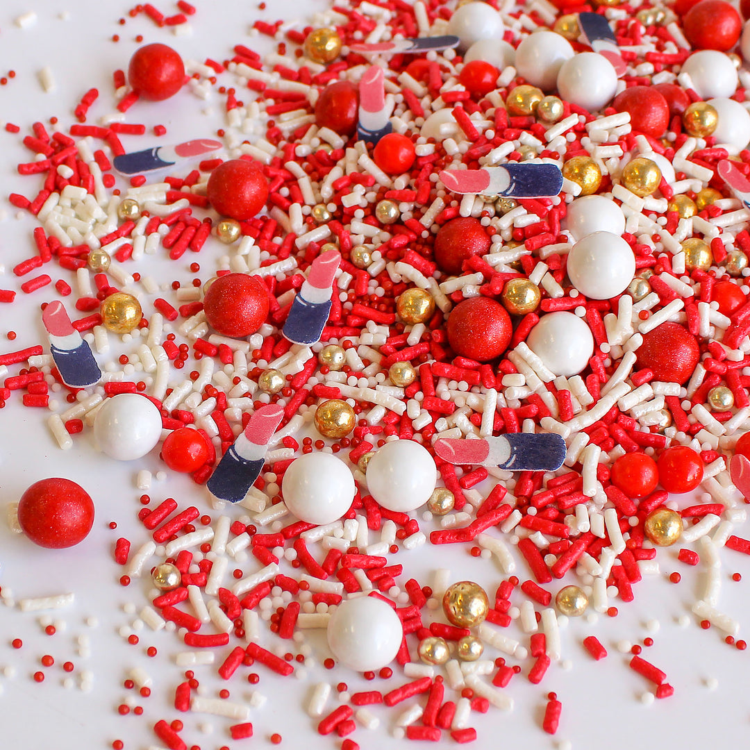 Red Sprinkle Mix - Vibrant blend of red, white, and gold sprinkles with wafer paper lipsticks, perfect for adding glamour to your culinary creations.