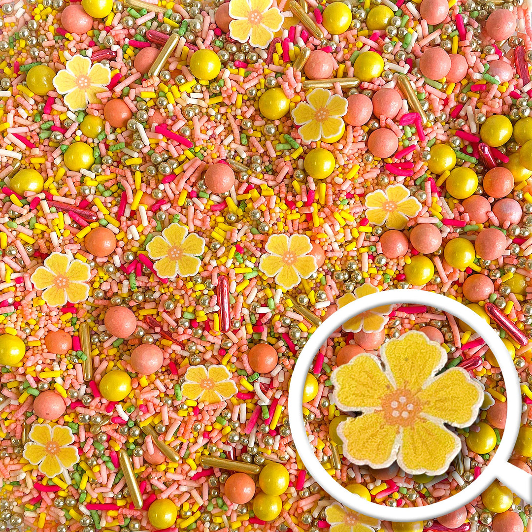 Petal Party Sprinkle Mix - A blend of peach and pink sprinkles with delicate yellow blossoms, ideal for cake decorating.