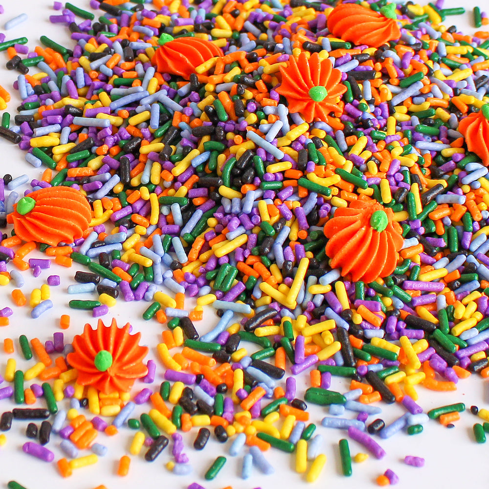 Close-up of Pumpkin Potion Sprinkle Mix with vibrant fall colors and hand-piped royal icing pumpkins.