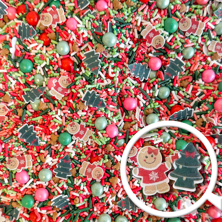 Colorful Little Miss Christmas Sprinkle Mix featuring red, green, and pink sprinkles with gingerbread cookies, Christmas trees, and festive pearls.