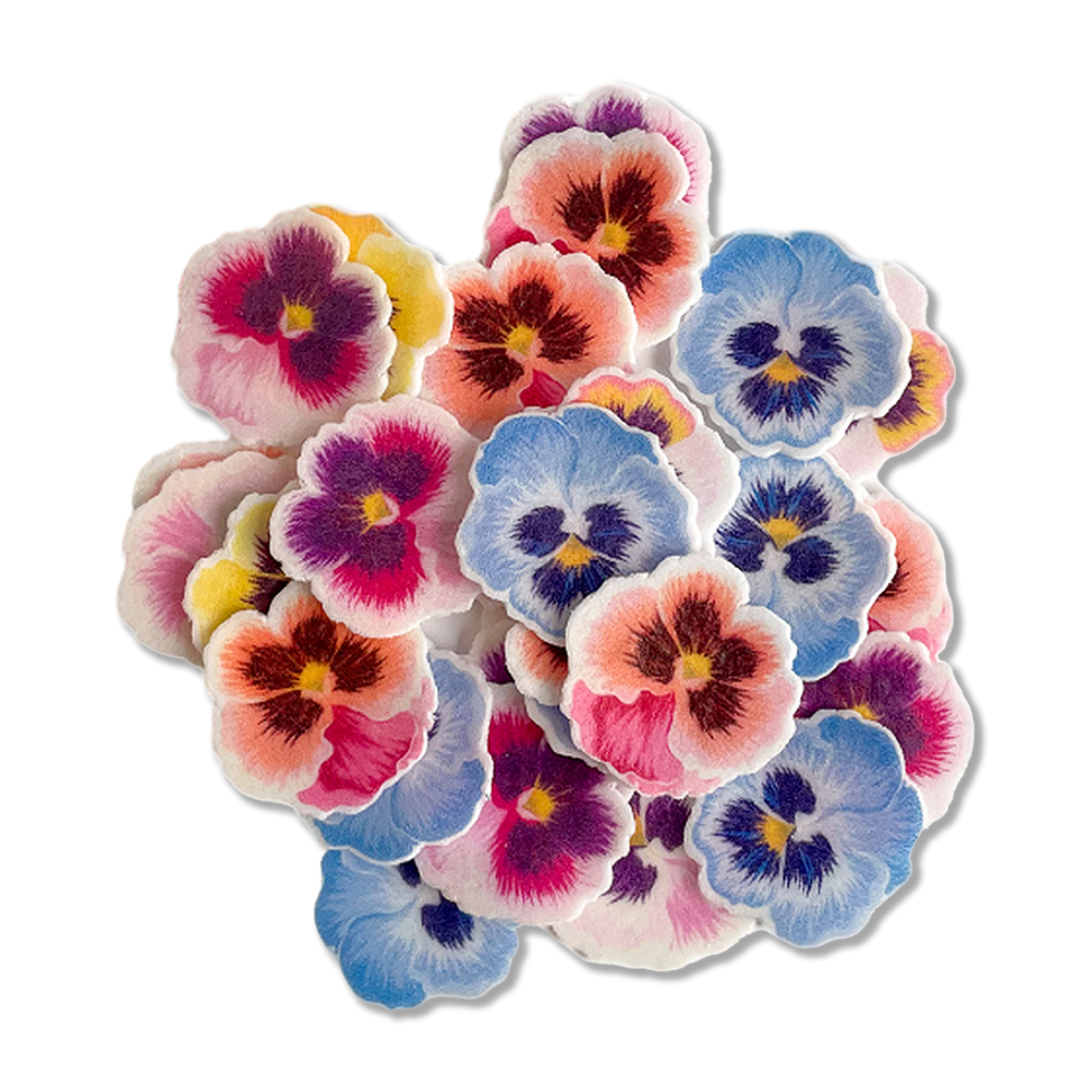 A close-up of Pansies Wafer Sprinkles, featuring vibrant purple, pink, yellow, and blue hues, perfect for spring baking adventures and Mother’s Day treats.
