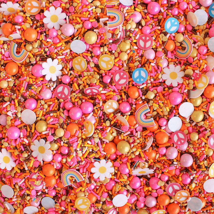 A colorful sprinkle mix with flower, rainbow, and peace sign wafer pieces.