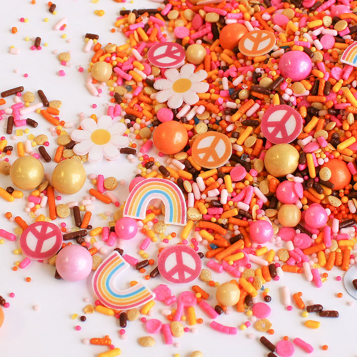 A colorful sprinkle mix with flower, rainbow, and peace sign wafer pieces.