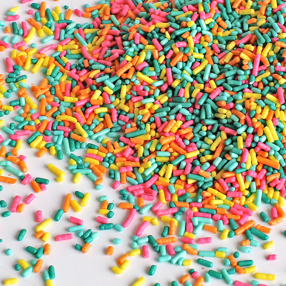 Image of Summer Vibes Sprinkle Mix with vibrant pink, yellow, orange, and teal sprinkles in a summery setting.