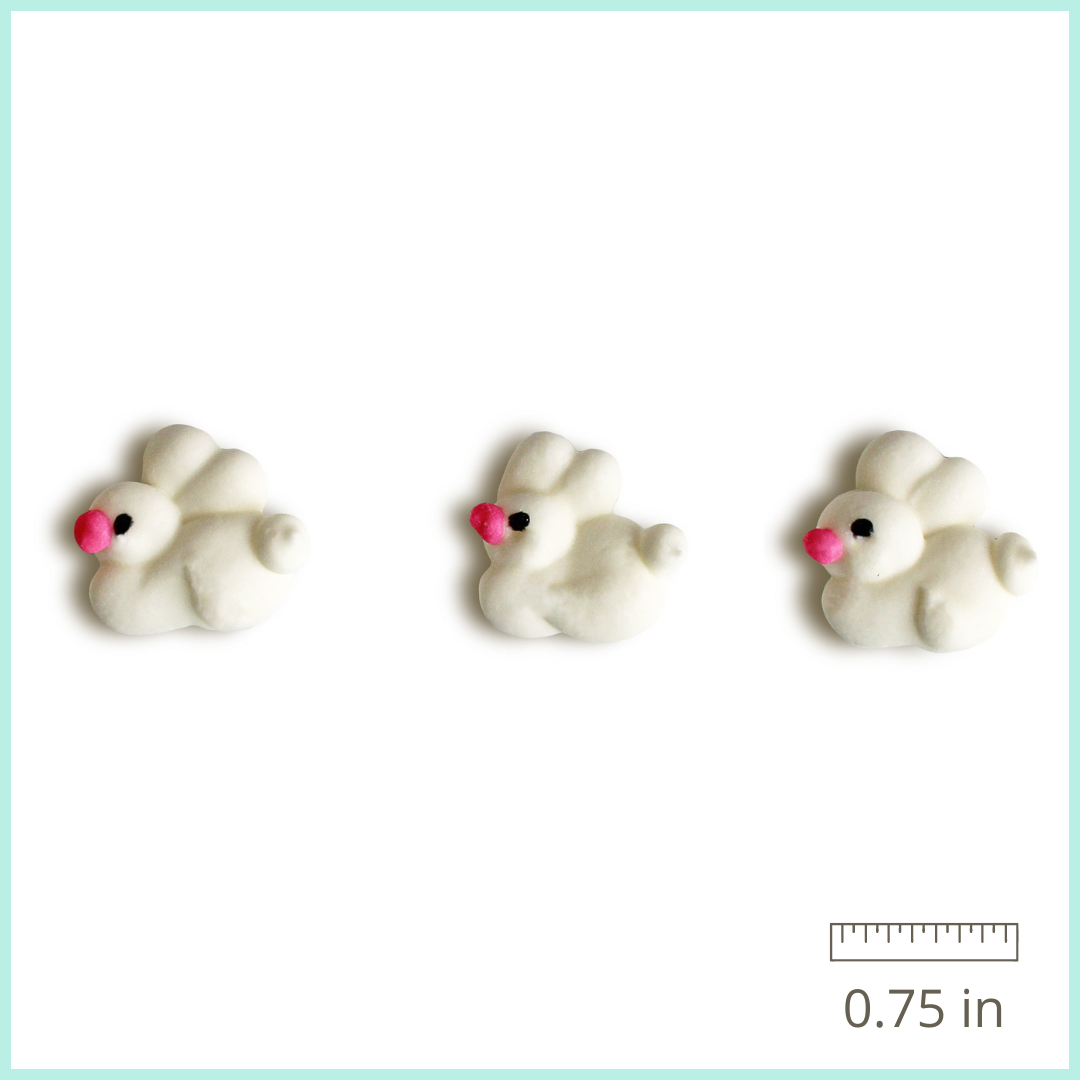 Twelve hand-piped royal icing bunny decorations, featuring a variety of adorable poses and expressions, perfect for Easter and springtime treats. Each bunny is approximately 0.75 inches in size and is expertly crafted from high-quality royal icing. These whimsical bunnies can be used to decorate cakes, cupcakes, cookies, and more. Their long shelf life of 5 years means they can be enjoyed for seasons to come. Add a playful touch to your baked goods with these charming royal icing bunny decorations.