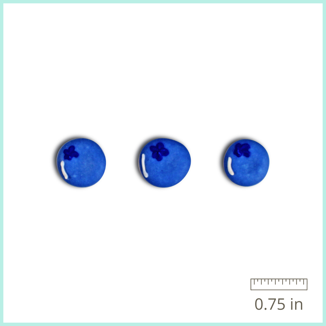 A dozen hand-piped Royal Icing Blueberries with a sweet vanilla flavor, perfect for adding a pop of color and fruity flavor to your baked goods.
