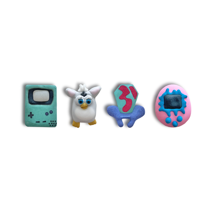 90's Collection set of hand-piped royal icing featuring a ring pop, a tamagachi, a furby and a gameboy