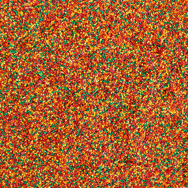 Close-up of Autumn Nonpareils - a mix of red, warm yellow, orange, burgundy, and green sprinkles, perfect for fall treats.
