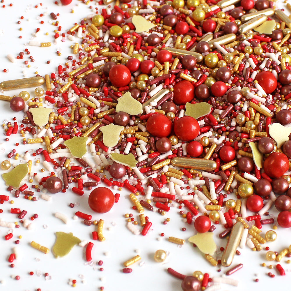Carol of the Bells Sprinkle Mix, featuring bright gold, burgundy, and red sprinkles with metallic gold wafer Bells.