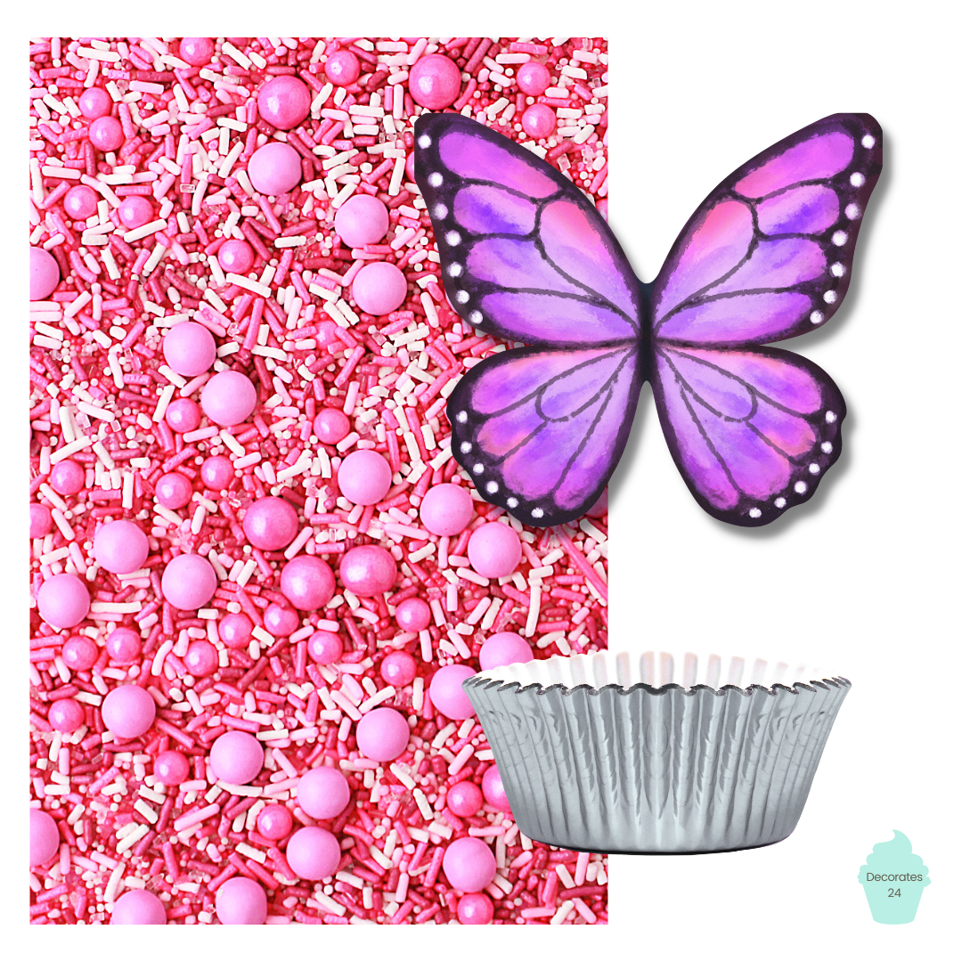 A photo of a pink cupcake with a pink butterfly cupcake topper on top, surrounded by pink ombre sprinkle mix and silver cupcake liners. 