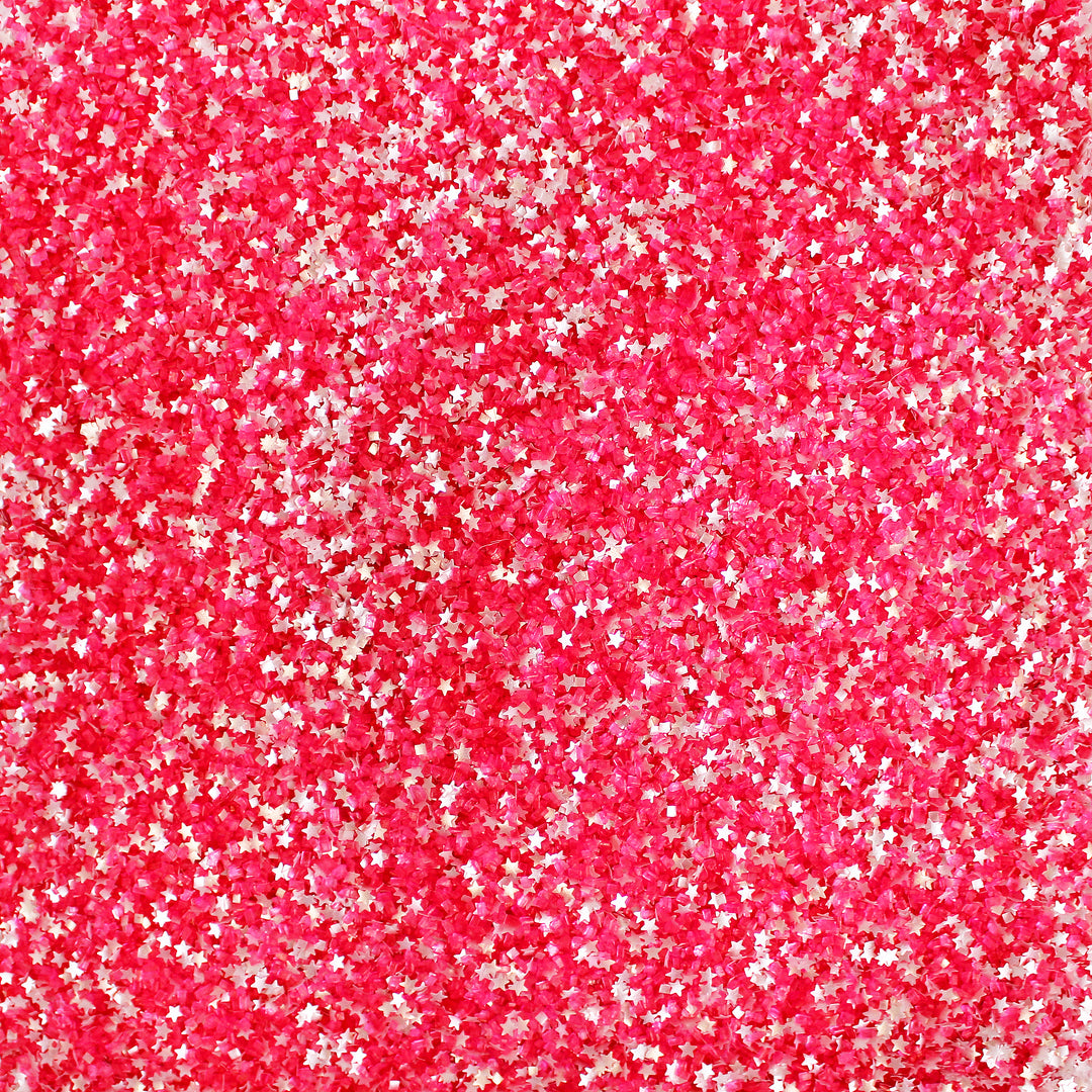 An image of hot pink Strawberry Flavored Sugar Sprinkles with silver glitter stars. The packaging features the Strawberry Shortcake logo and the words "Strawberry Flavored Sugar Sprinkles" in playful, whimsical font.