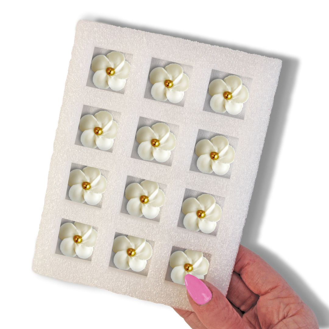  White flower with gold dragee center - Elegant royal icing decoration for wedding cakes and treats.