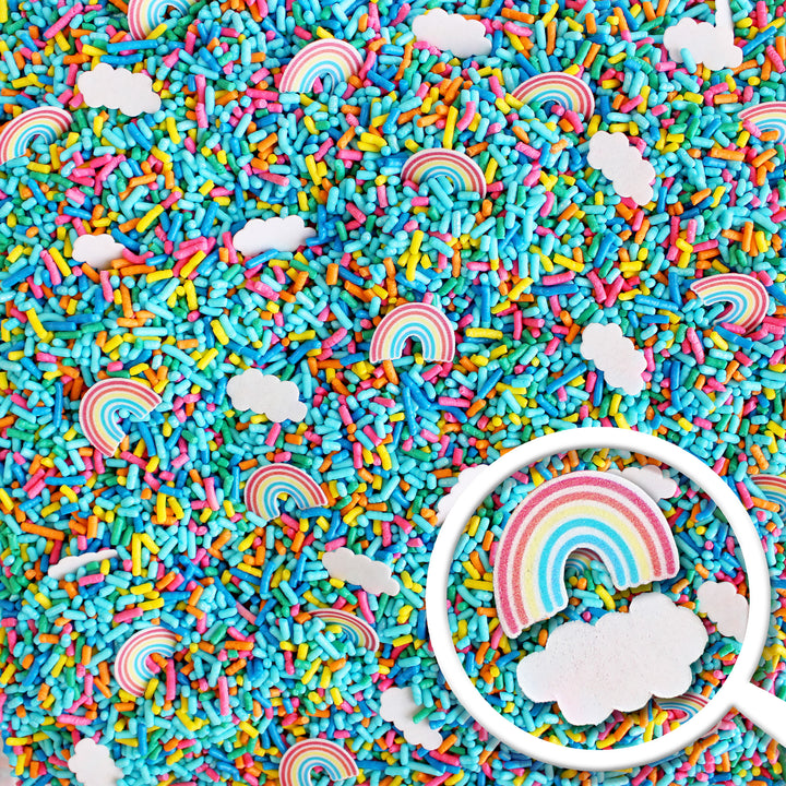 An image of "You're My Rainbow" Sprinkle Mix in a clear plastic container with a colorful burst of rainbow sprinkles, wafer paper clouds, and rainbows on top. The packaging features the words "You're My Rainbow" in playful, whimsical font.